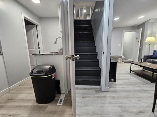 a hallway with a trash can and a staircase at Beach Apt In Woodmontmilford in Milford
