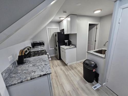 a small kitchen with white cabinets and a sink at Beach Apt In Woodmontmilford in Milford