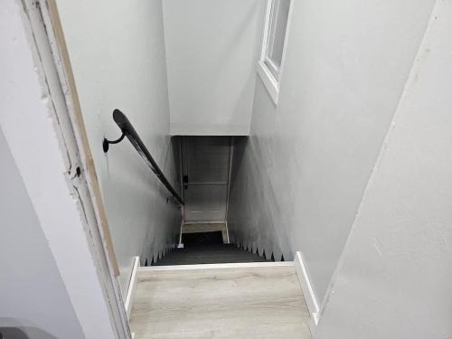 a hallway with a stairway leading to a room at Beach Apt In Woodmontmilford in Milford