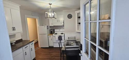 a kitchen with white cabinets and a table in it at Private Apt In Middletown-wesleyan in Middletown