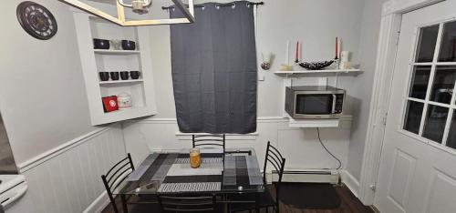 a dining room with a table with chairs and a tv at Private Apt In Middletown-wesleyan in Middletown