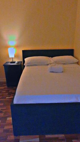a bedroom with a large bed with a light on it at Oceanview Suites in Saint Georgeʼs