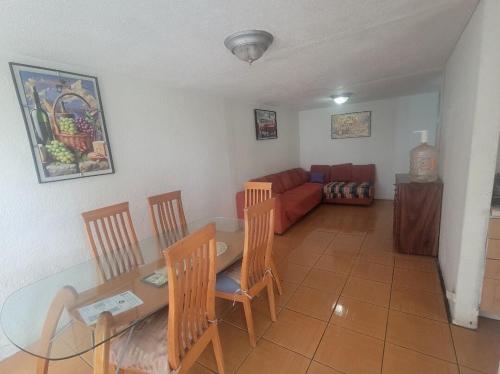 a living room with a table and chairs and a couch at Aguilas House 2 Alojamiento entero 3 habitaciones in Guadalajara