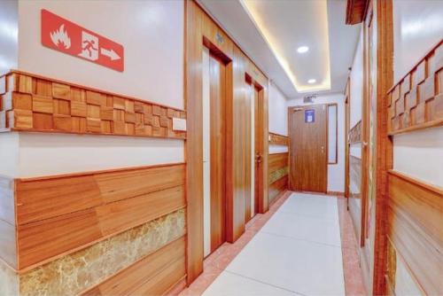 a corridor of a building with wood paneling and a hallway at Pushap villa katra in Katra