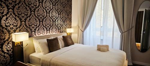 a hotel room with a bed and a window at STOA ROME Boutique Suites in Rome