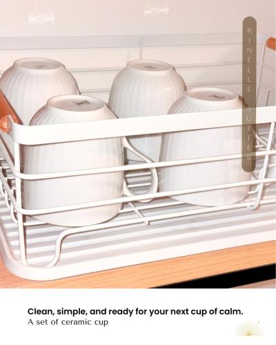 a shelf with white pots and vases on it at Stylish 2BR Apt at PIK 2 Rinelle in Muara