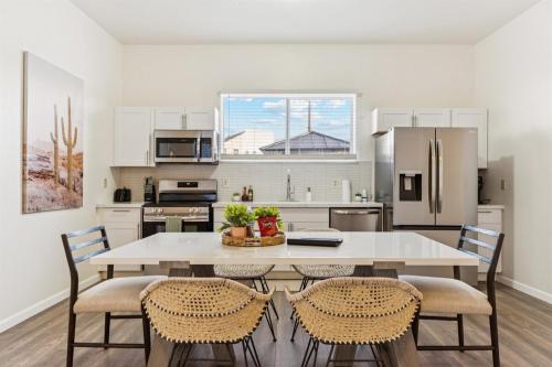 a kitchen with a large white table and chairs at Relaxing Casita - Pool - Spa - Prime Location in Phoenix
