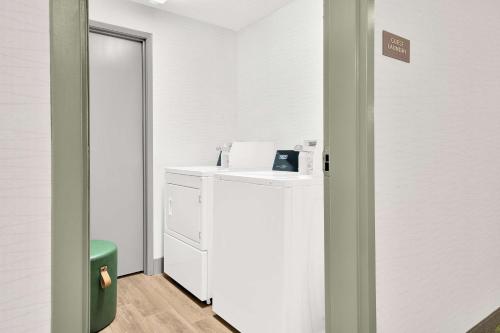 a room with a white refrigerator and a sink at Spark By Hilton Toronto Markham in Markham