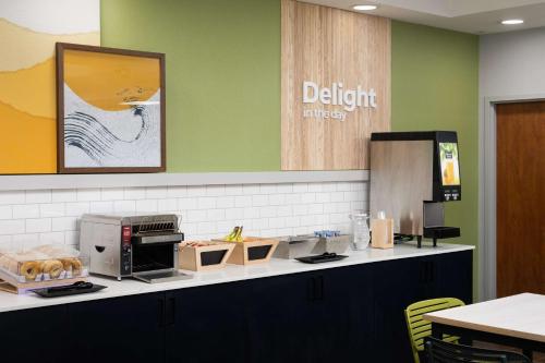 a kitchen with a counter top with a microwave at Spark By Hilton Guelph in Guelph