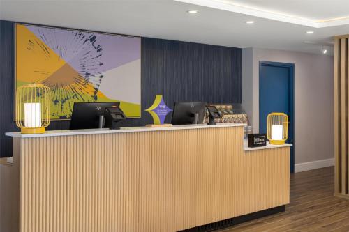 a lobby with a reception desk with computers on it at Spark By Hilton Woodstock in Woodstock