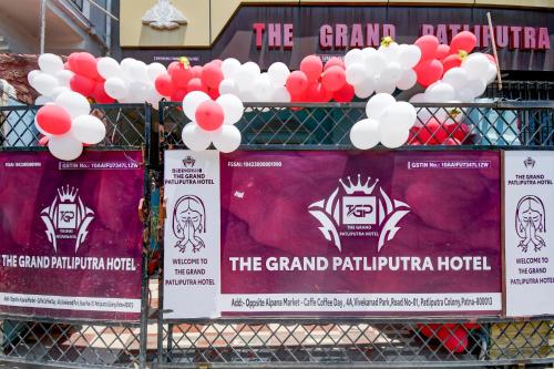 a bunch of signs on a fence with red and white balloons at Hotel O The Grand Patliputra in Patna