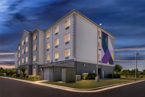 a building with a flag in front of it at Spark by Hilton Homewood Birmingham in Birmingham