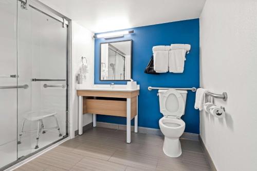 a bathroom with a toilet and a sink and a mirror at Spark by Hilton Oxford in Oxford