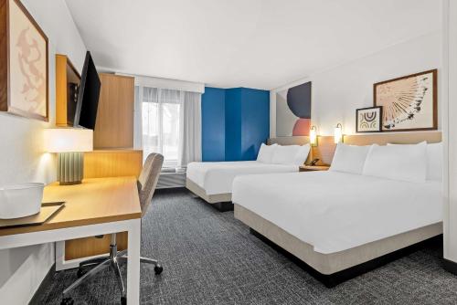 a hotel room with two beds and a desk at Spark by Hilton Oxford in Oxford
