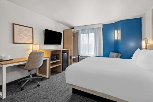 a hotel room with a bed and a desk and a computer at Spark by Hilton Oxford in Oxford