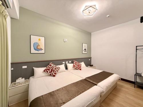 a bedroom with a large bed with pillows on it at Happy Villa Sea View B&B in Magong