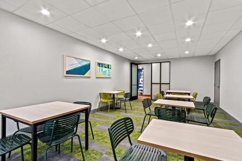 a classroom with tables and chairs in a building at Spark by Hilton Phoenix East Mesa in Mesa