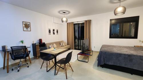 a bedroom with a bed and a table and chairs at Studio em Sorocaba no Campolim in Sorocaba