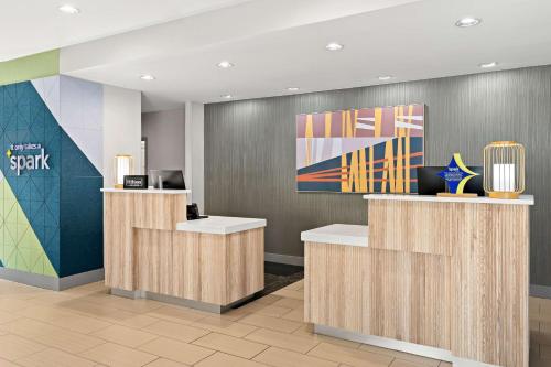 an office lobby with reception desks and a painting at Spark by Hilton Little Rock West in Little Rock