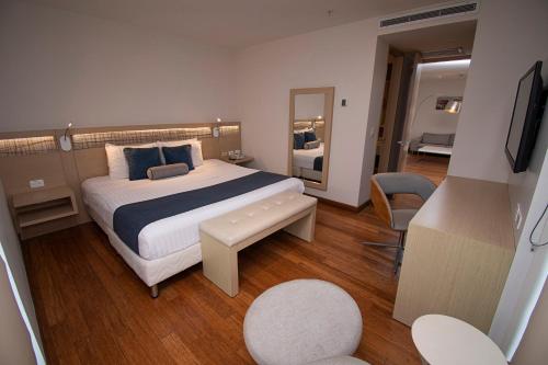 a hotel room with a bed and a television at Cosmos Pacifico Hotel in Buenaventura