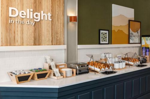a bakery counter with croissants and other food items at Spark By Hilton Mystic Groton in Mystic