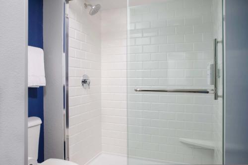 a bathroom with a shower with a glass door at Spark by Hilton Miami Doral in Miami