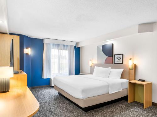 a hotel room with a large bed and a window at Spark by Hilton Augusta in Augusta
