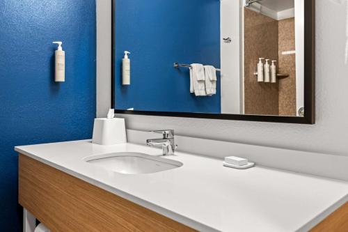 a bathroom with a white sink and a mirror at Spark by Hilton Port Wentworth Savannah in Port Wentworth