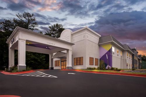 a large white building with a parking lot at Spark by Hilton Duluth in Duluth