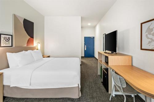 a hotel room with a large bed and a desk at Spark by Hilton Duluth in Duluth