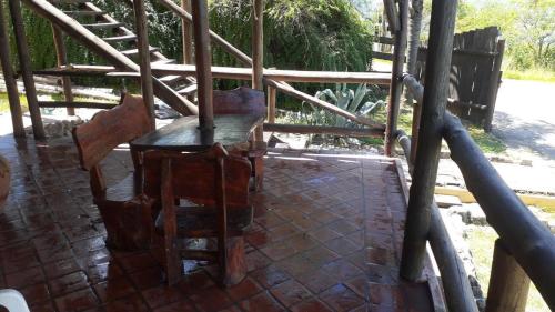 a table and chairs sitting on a brick patio at Cabañas Terrazas del Sol in Villa Carlos Paz