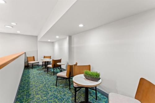 an empty waiting room with tables and chairs at Spark By Hilton Oak Forest I-57 in Oak Forest