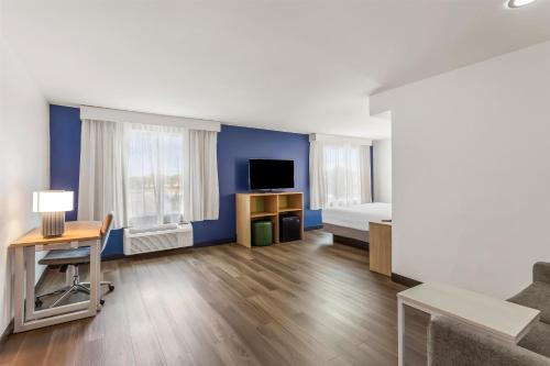 a hotel room with a bed and a desk and a tv at Spark By Hilton Oak Forest I-57 in Oak Forest