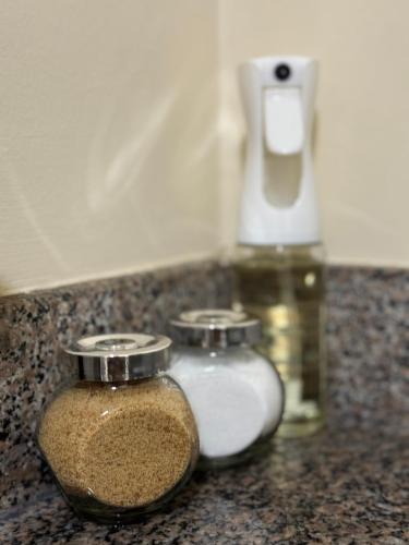 two glass jars on a counter with a soap dispenser at Milenio in Manta