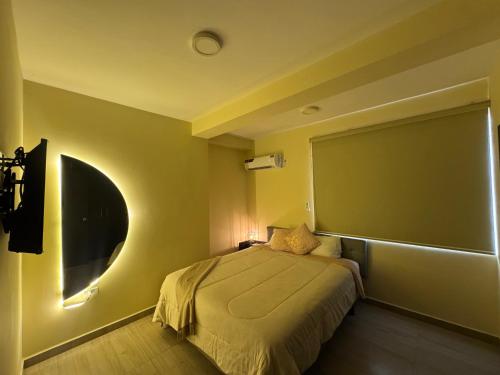 a bedroom with a bed and a large window at Milenio in Manta
