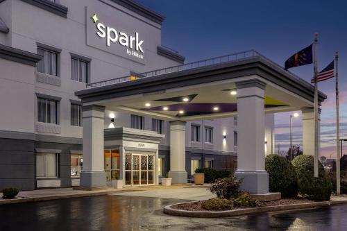 a hotel front of a building at night at Spark By Hilton Evansville East, In in Evansville