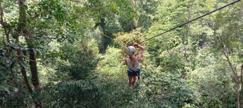 a person on a zip line in the forest at Casa Azul with Private Pool - Tropical Oasis - WiFi-AC-Bikes-Surfboards- Walk to point in Pavones
