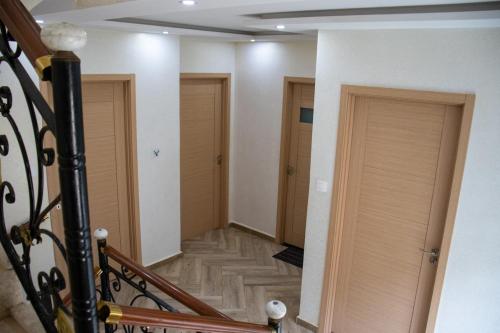 a hallway with doors and stairs in a building at Villa 3 niveau avec jacuzzi, terrasse et cour in Birkhadem