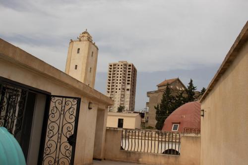 a view of a city with a gate and buildings at Villa 3 niveau avec jacuzzi, terrasse et cour in Birkhadem