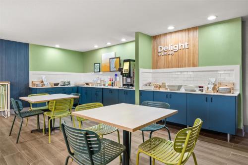 a dining area with tables and chairs in a dental office at Spark By Hilton Eden Prairie in Eden Prairie