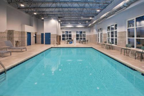 a large swimming pool in a building at Spark by Hilton Walker Grand Rapids North in Grand Rapids