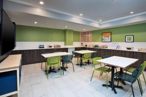a fast food restaurant with tables and chairs at Spark by Hilton Walker Grand Rapids North in Grand Rapids