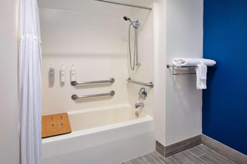 a bathroom with a shower and a bath tub at Spark by Hilton Walker Grand Rapids North in Grand Rapids