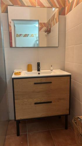 a bathroom with a sink and a mirror at Douce Evasion in Bouillante