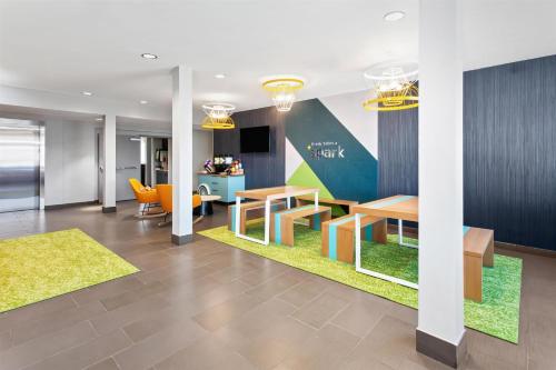 an office lobby with desks and a table at Spark by Hilton Rochester South in Rochester