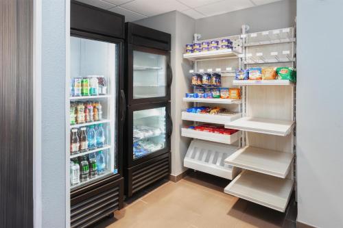 a kitchen with an open refrigerator with lots of food at Spark by Hilton Rochester South in Rochester