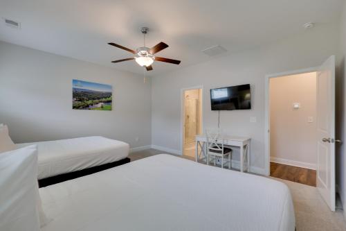 a bedroom with two beds and a ceiling fan at 3 Mi to Golf and Waterway Ocean Isle Beach Retreat! in Ocean Isle Beach