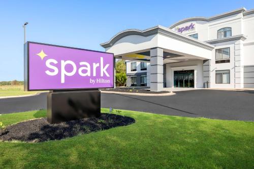a sign in front of a park by hilton building at Spark By Hilton Tupelo in Tupelo