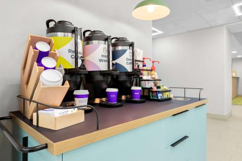 a counter with a bunch of cups on it at Spark By Hilton Tupelo in Tupelo