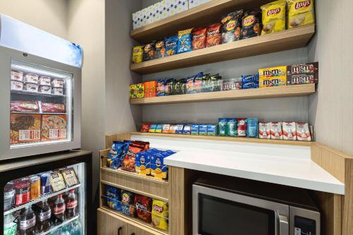 a kitchen with a pantry with food and a refrigerator at Spark By Hilton Las Vegas Airport in Las Vegas